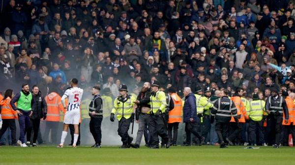 Police officers on the pitch. Pic: PA