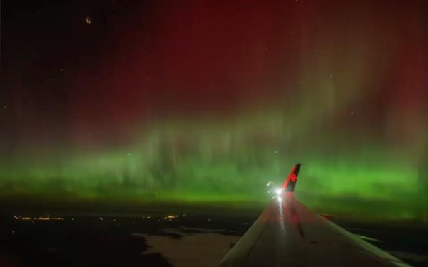 A traveller's view of the aurora from their flight landing into Christchurch at midnight on 12 May, 2024.