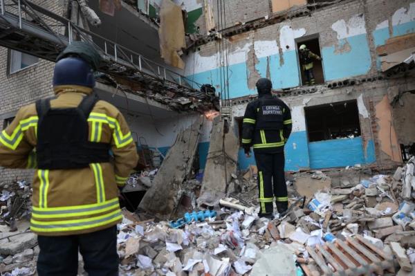 Rescue teams in the rubble of a hospital in Selydove that was hit by a Russian missile