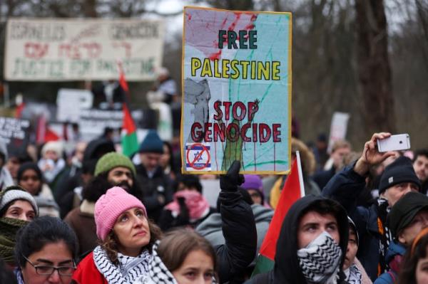 Pro-Palestinian demo<em></em>nstrators hold Palestinian flags as they protest near the Internatio<em></em>nal Court of Justice (ICJ