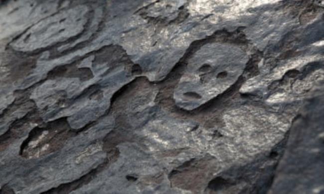 Ancient carvings on Amazon river rock exposed by falling water level during drought in Manaus