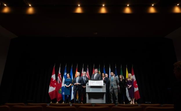 Cabinet members, police and municipal leaders surround Minister of Public Safety Dominic LeBlanc as he speaks during a news co<em></em>nference at the Natio<em></em>nal Summit on Combatting Auto Theft, in Ottawa, Thursday, Feb. 8, 2024.