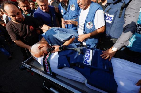 Mourners attend the funeral of Palestinian journalist Mohammed Abu Hattab