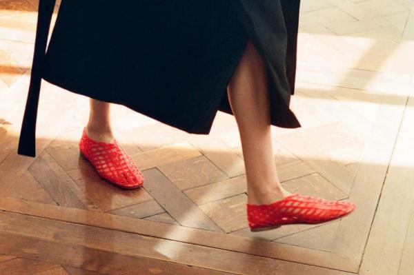 A person wearing trendy 90s style red jelly sandals