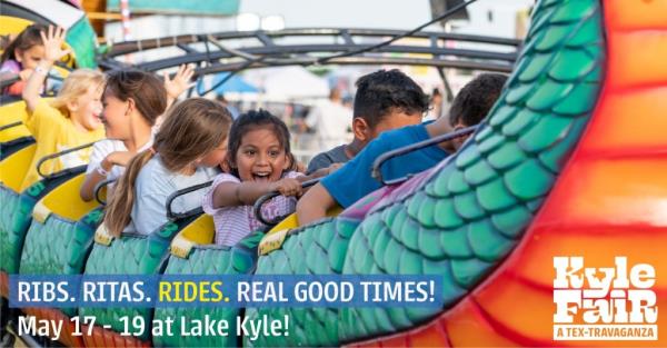 Kids ride a rollercoaster at the 2023 Kyle Fair.