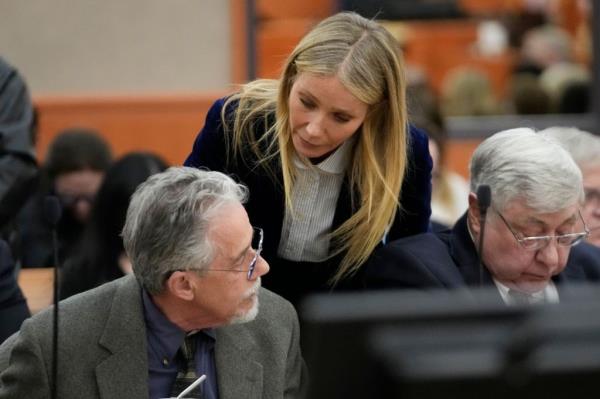 Gwyneth Paltrow speaks with retired optometrist Terry Sanderson as she walks out of the courtroom following the reading of the verdict in the trial over her 2016 ski collision with 76-year-old Terry Sanderso<em></em>non the final day of her eight-day trial in Park City, Utah.