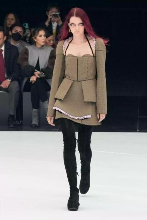 Givenchy model wearing skirt suit with peplum skirt design