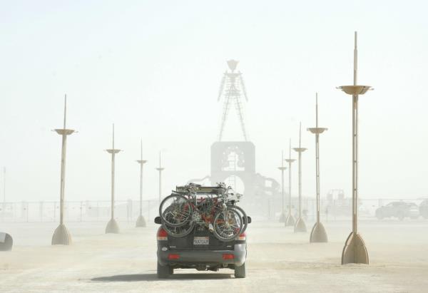 Car with bikes driving into Burning Man.