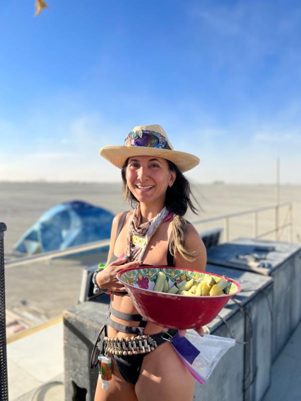 Tanya Khani at Burning Man holding a bowl. 