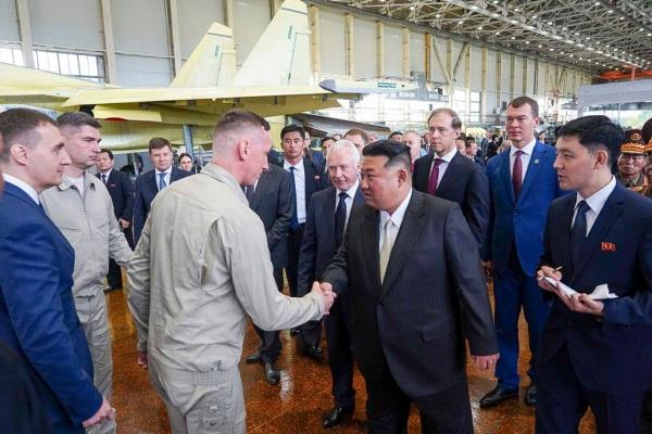 North Korean leader Kim Jong Un, center, shakes hands with employees while visiting a Russian aircraft plant that builds fighter jets in Komsomolsk-on-Amur, a<em></em>bout 6,200 kilometers (3,900 miles) east of Moscow, Russia.