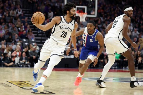 Spencer Dinwiddie dribbles past De'Aaron Fox #5 of the Sacramento Kings in the first half at Golden 1 Center.