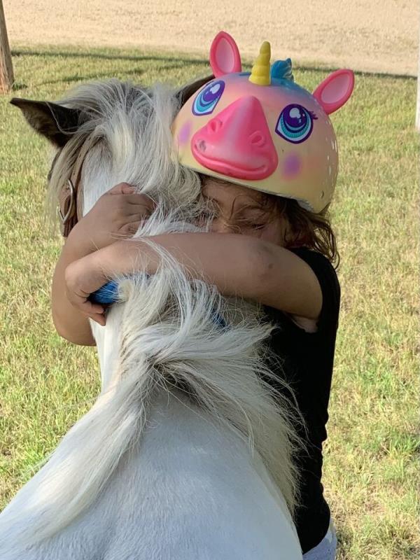 Penny getting a hug from a child.