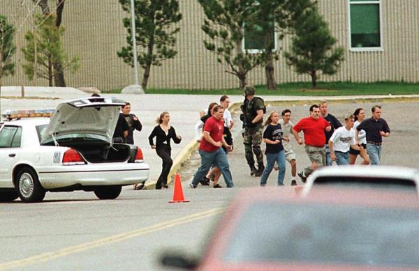 Students run from Columbine High School on the morning of April 20, 1999, as two students begin shooting.