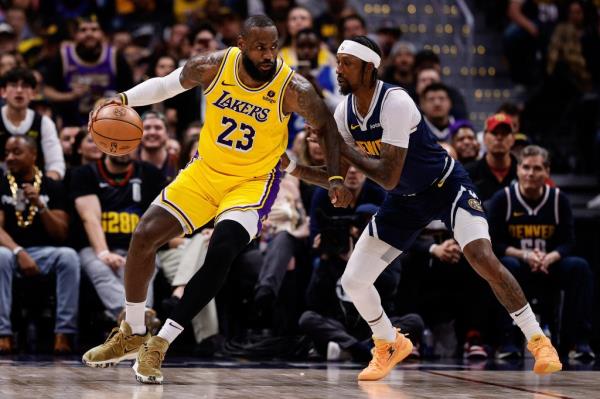 Lakers forward LeBron James (23) controls the ball as Denver Nuggets guard Kentavious Caldwell-Pope (5) guards in the third quarter during game five of the first round for the 2024 NBA playoffs at Ball Arena on April 29, 2024. 