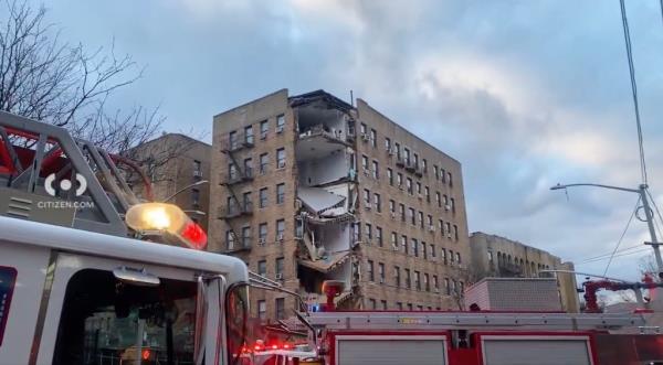 The facade of a Bronx building showing exposed apartment after a partial collapse.