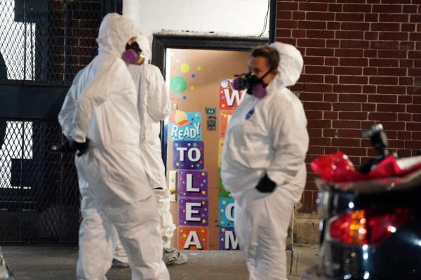 investigators wear hazmat suits outside Bronx day care