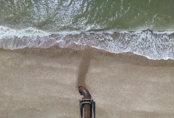 A waste water outflow pipe at low tide on Pagham Beach in Bognor Regis, UK, on Wednesday, May 31, 2023. As well as the threat of water shortages, underdeveloped pipes and treatment plants mean raw sewage is frequently dumped in rivers and the sea, causing enviro<em></em>nmental damage. Photographer: Jason Alden/Bloomberg via Getty Images