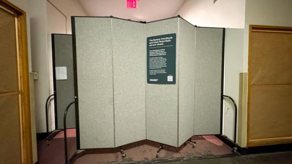 Rolling walls seen blocking off parts of the Native American exhibit space at the Museum of Natural History with sign explaining new federal regulations.