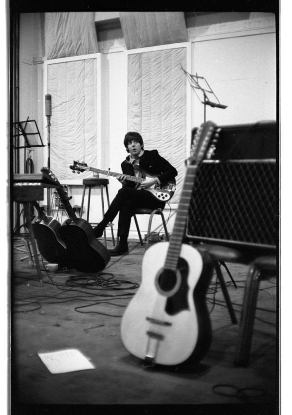 A photo of the 12-string guitar, with Paul McCartney in the background.