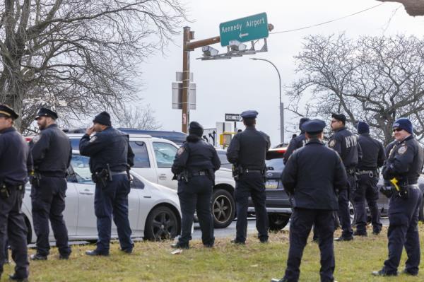 Photo of a<em></em>bout a dozen cops outside JFK Airport.