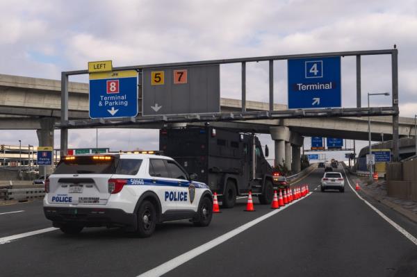 Police vehicles positio<em></em>ned at JFK airport entrance with supporters of Palestine protesting. 