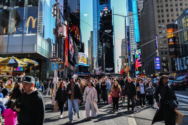 Tourists navigating through Times Square in New York City on April 7, 2024