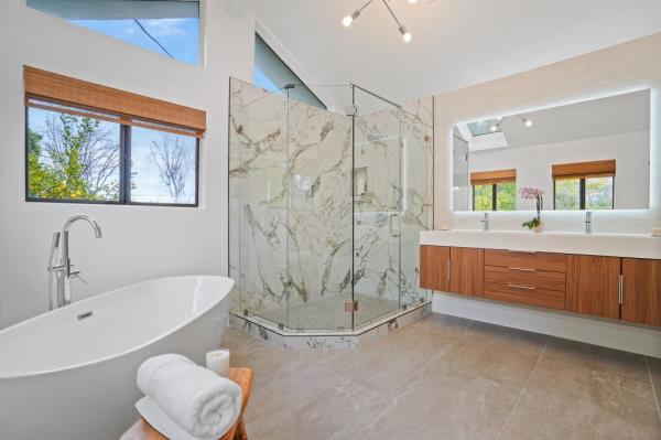 The primary bathroom has a stand-alone tub and a glass shower. 