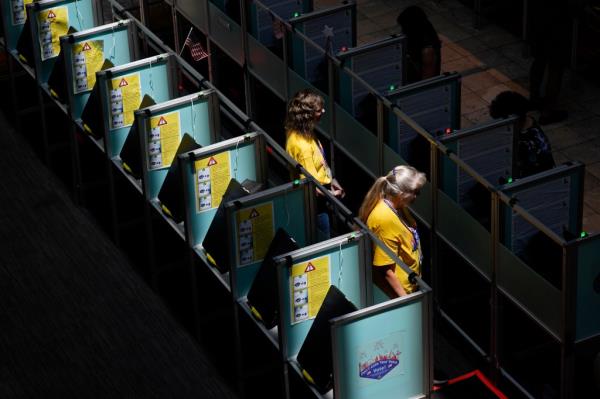 Poll workers in help people vote in the Nevada primary at a polling place, Tuesday, June 11, 2024, in Henderson, Nev. (AP Photo/John Locher)