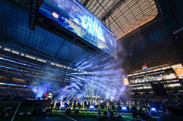 Singer Dolly Parton performs with the Dallas Cowboys cheerleaders during halftime of the game between the Dallas Cowboys and the Washington Commanders at AT&T Stadium on November 23, 2023 in Arlington, Texas.