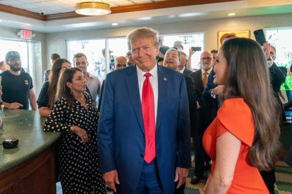 Former President Do<em></em>nald Trump smiles at the cameras as he visits Versailles restaurant on Tuesday, June 13, 2023, in Miami.