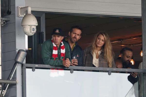 Reynolds (seen center with wife, Blake Lively, right) and fellow actor Rob McElhenney are owners of the Wrexham soccer team in Wales.