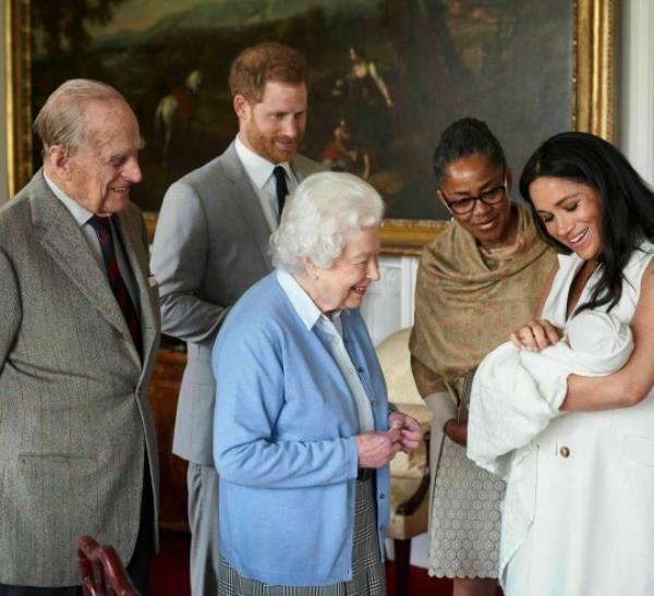 In this image provided by SussexRoyal, Britain's Prince Harry and Meghan, Duchess of Sussex, joined by her mother, Doria Ragland, show their new son to Queen Elizabeth II and Prince Philip at Windsor Castle, Windsor, England. Prince Harry and Meghan have named their son Archie Harrison Mountbatten-Windsor. (Chris Allerton/SussexRoyal via AP)