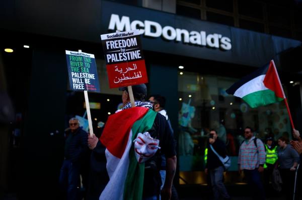 Pro-Palestinian activists in front of a McDonald's.