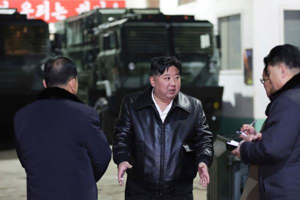 In this photo provided by the North Korean government, North Korean leader Kim Jong Un, center, inspects as he tours munitions factories in North Korea on Jan. 8-9, 2024. 