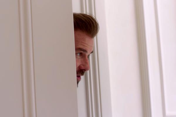 David Beckham with his head in a door. 