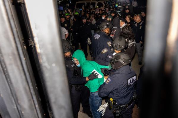 NYPD officers arresting protesters at the entrance of Columbia University during the clearance of a pro-Palestinian protest encampment