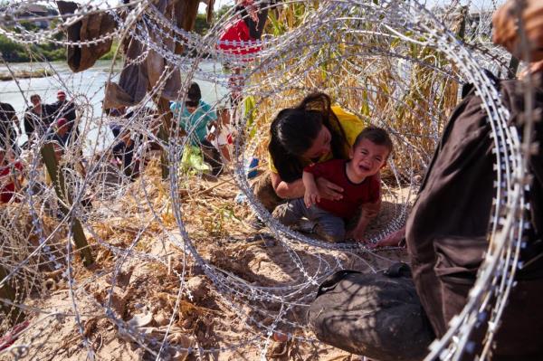 A mother from Ho<em></em>nduras crawled through co<em></em>ncertina wire with her three children after crossing the Rio Grande river from Mexico into the United States on Sunday, September 24, 2023