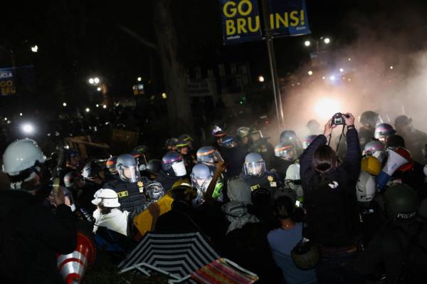 The detained protesters were seen on their knees with their hands zip tied behind their backs.