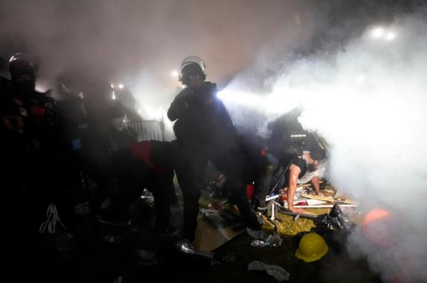 Police enter an encampment set up by pro-Palestinian demo<em></em>nstrators on the UCLA campus Thursday, May 2, 2024, in Los Angeles. 