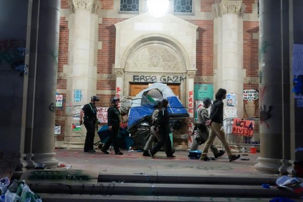 Demo<em></em>nstrators are escorted out of a pro-Palestinian encampment on the UCLA campus Thursday, May 2, 2024.