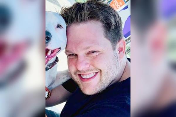 Jordan Willis, a smiling Kansas City Chiefs fan and HIV scientist, pictured outside his home