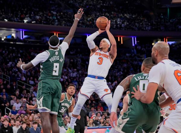 Knicks guard Josh Hart #3 puts up a shot as Milwaukee Bucks forward Bobby Portis #9 defends