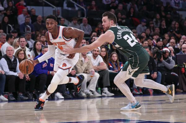 Knicks guard RJ Barrett (9) drives to the basket asMilwaukee Bucks guard Pat Co<em></em>nnaughton (24) defends