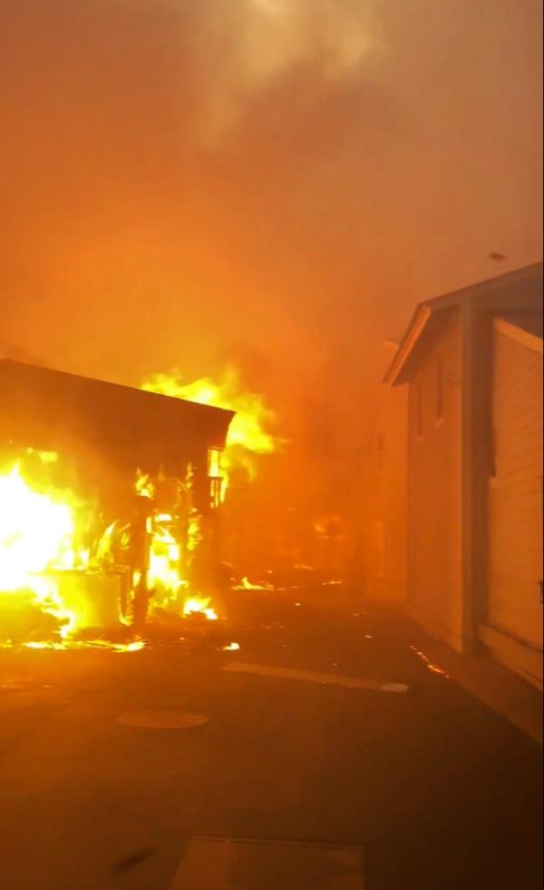 A home is pictured burning on Front Street in Lahaina. 