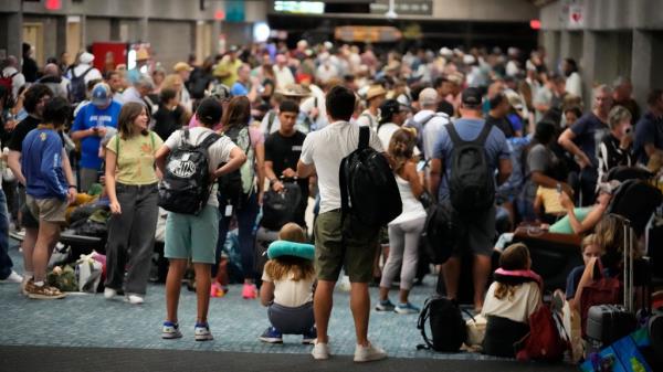 Evacuees are pictured waiting for their flights at Kahului Airport on Wednesday night. 