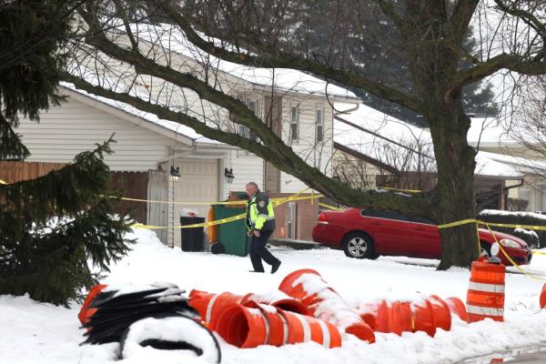 A Joliet police officer surveyed the crime scene on Tuesday.