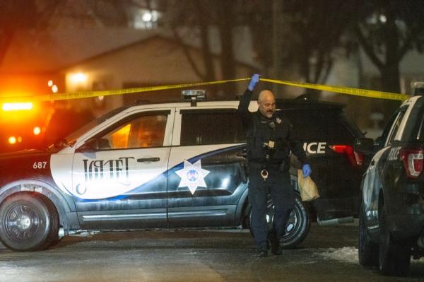 A Joliet police officer is pictured on the scene.