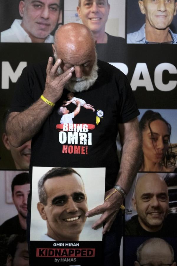 Dani Miran tears up as he called for his son to be freed from Gaza on Jan. 11. 