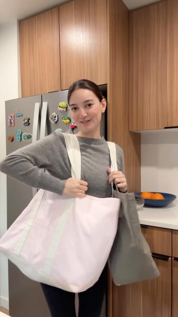 Emily Mariko wearing her two tote bags