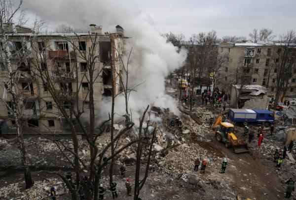 Rescuers work at a site of a residential building heavily damaged during a Russian missile attack, amid Russia's attack on Ukraine, in Kharkiv, Ukraine January 23, 2024. 